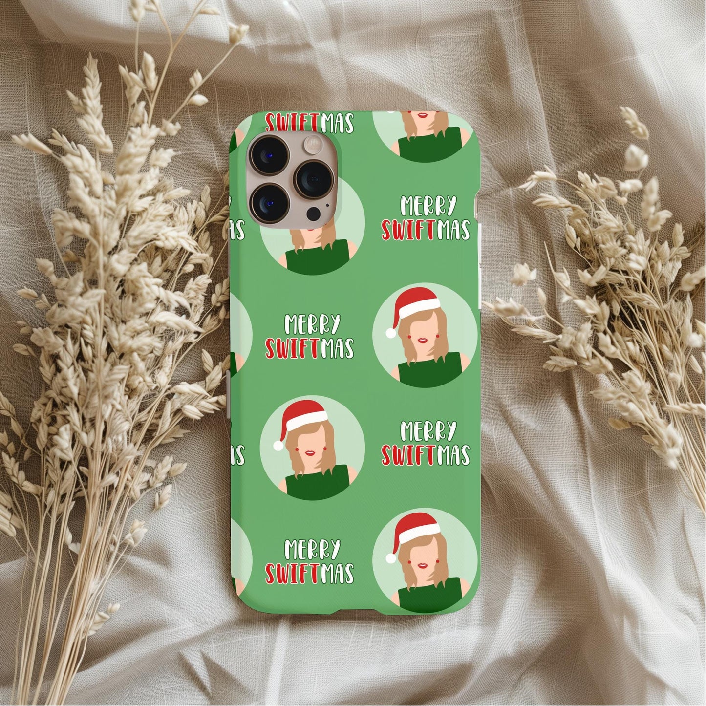 Taylor Swift Merry Swiftmas Phone Case with festive green design and holiday-themed illustrations on beige fabric background