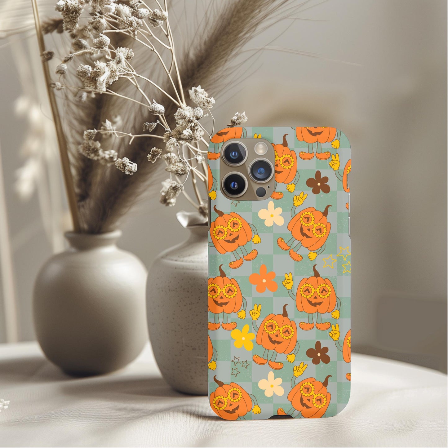 Groovy Pumpkins Phone Case with playful orange pumpkin design and floral accents on soft green background.
