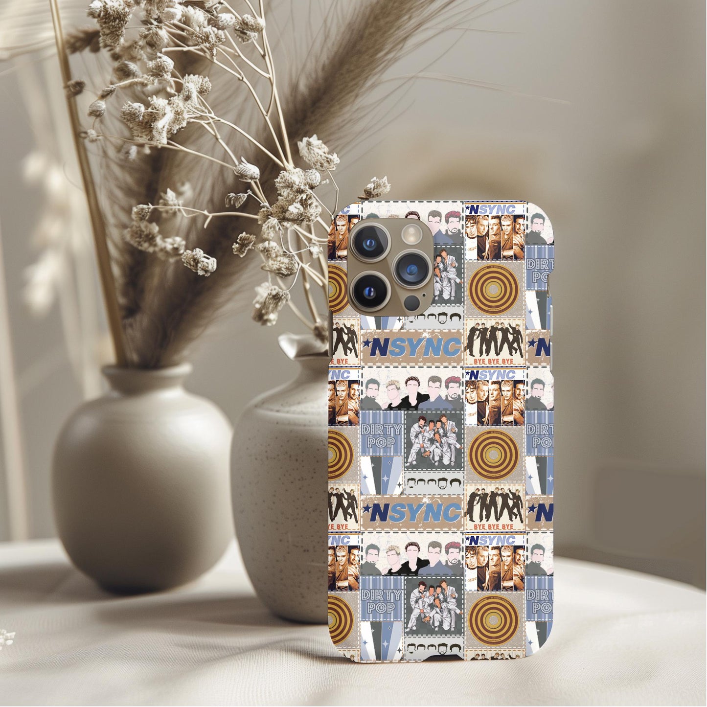 NSYNC Patchwork Phone Case with retro collage design featuring images and logos on a smartphone placed on a neutral background