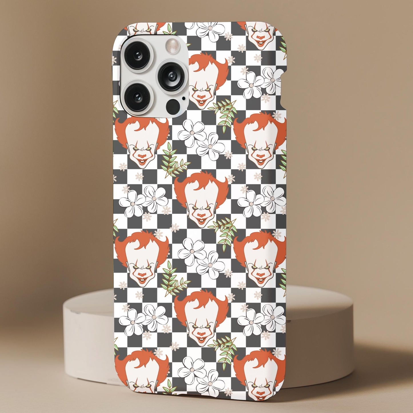 Floral Clown It Phone Case with a black and white checkerboard pattern, clown faces, and white floral accents.