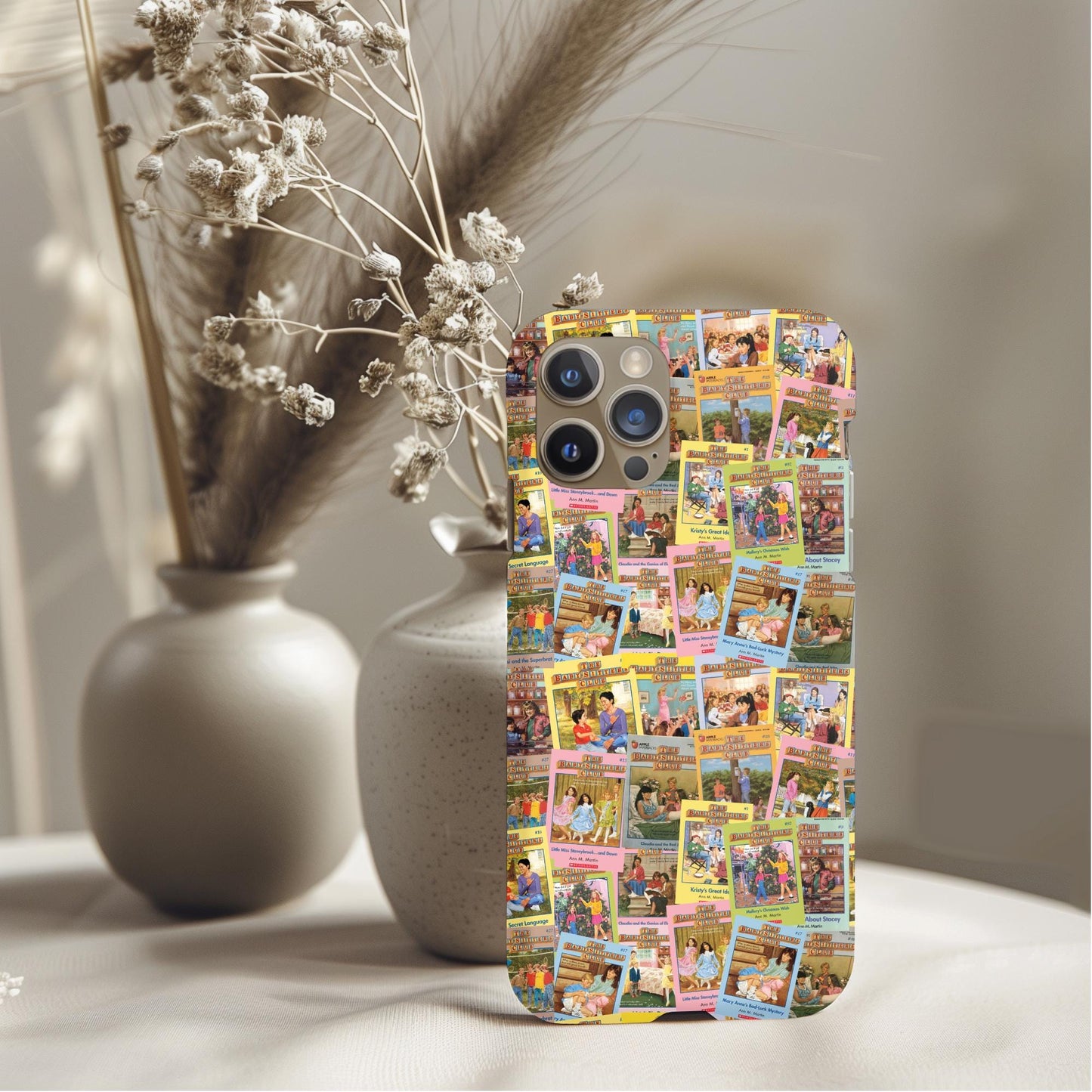 Nostalgic Babysitter Club Books Phone Case featuring colorful book cover collage on a phone against soft decor background