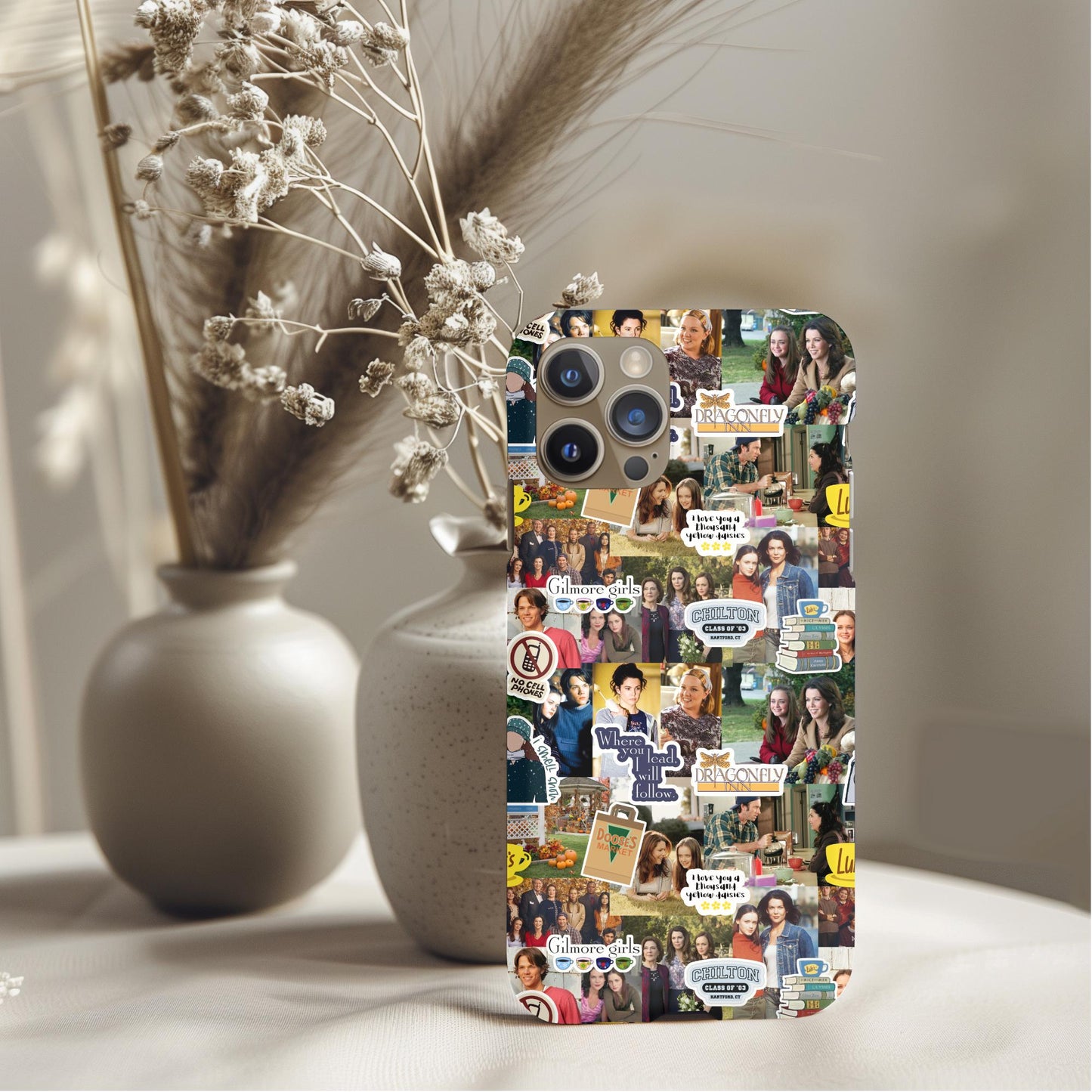 Gilmore Girls Collage Phone Case featuring characters and quotes on a decorative smartphone cover in a cozy setting