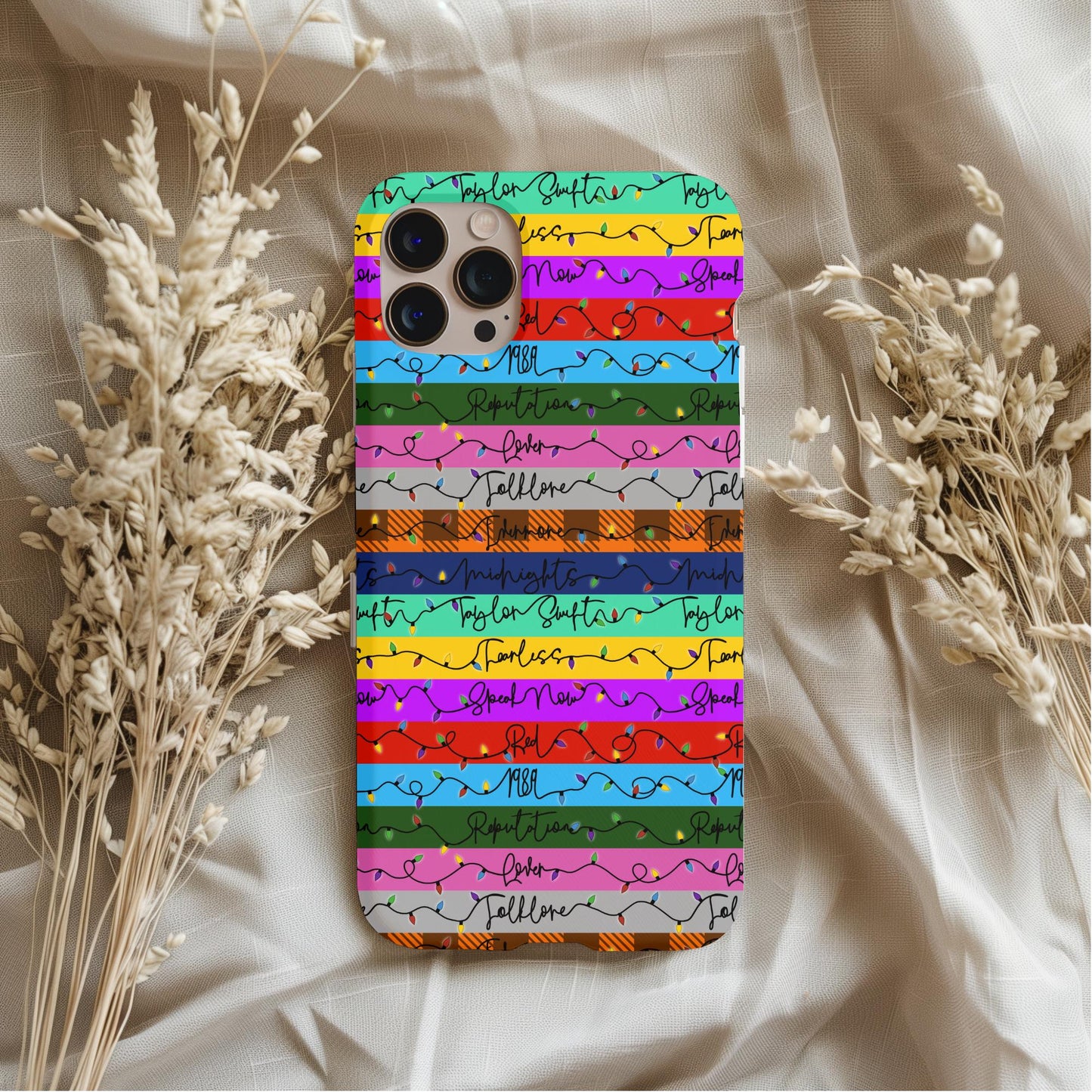 Taylor Swift Eras Christmas Phone Case with colorful stripes and festive string light design on a smartphone background