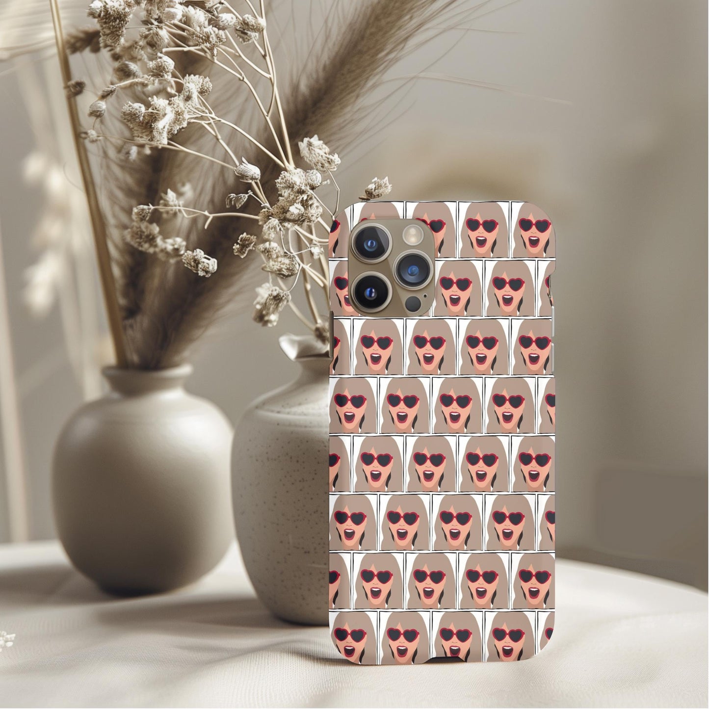 Surprised Taylor Swift Phone Case featuring repeated cartoon faces with heart-shaped sunglasses on beige background.