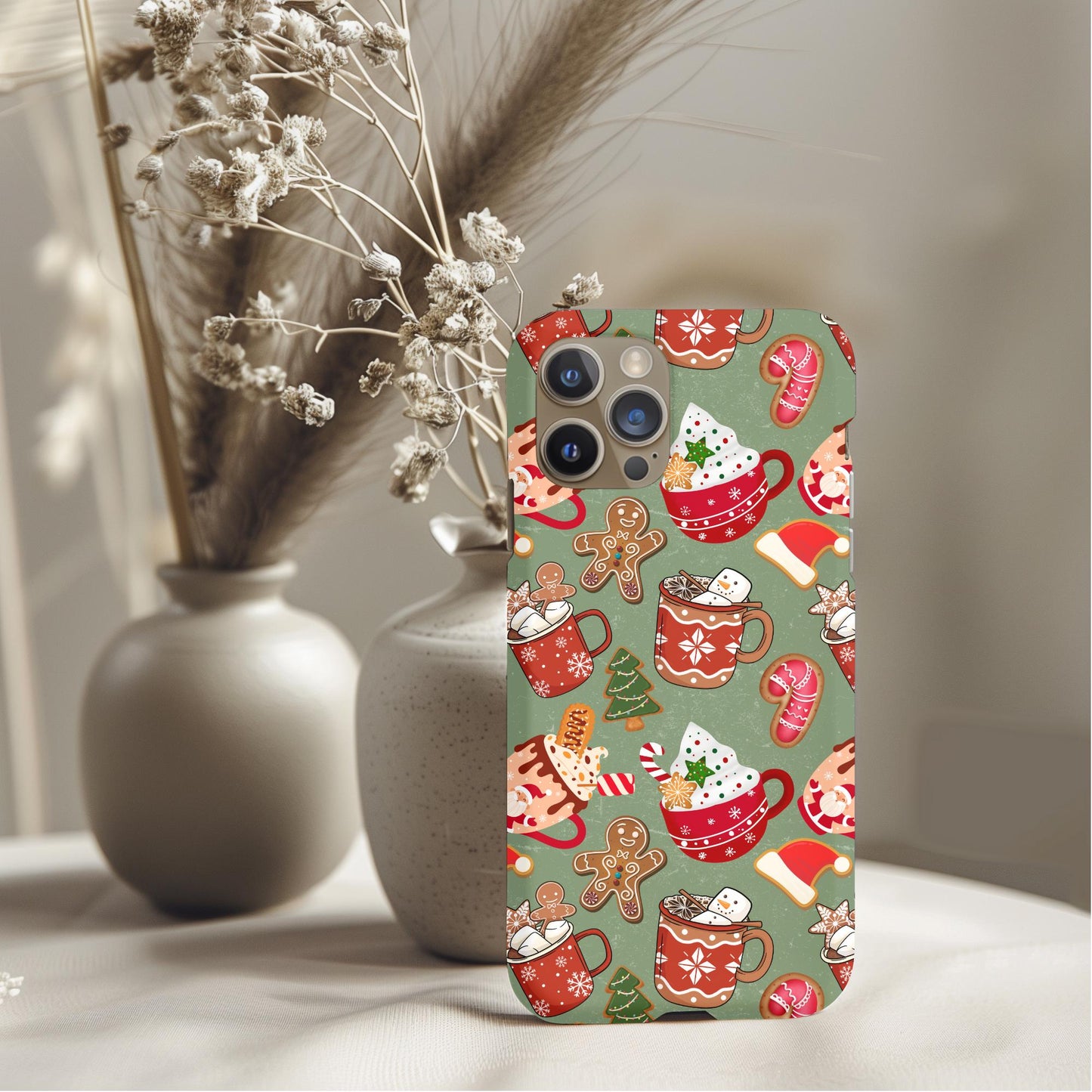 Christmas Hot Cocoa Candy Phone Case with festive mugs, gingerbread, candy canes, and holiday treats on a green background