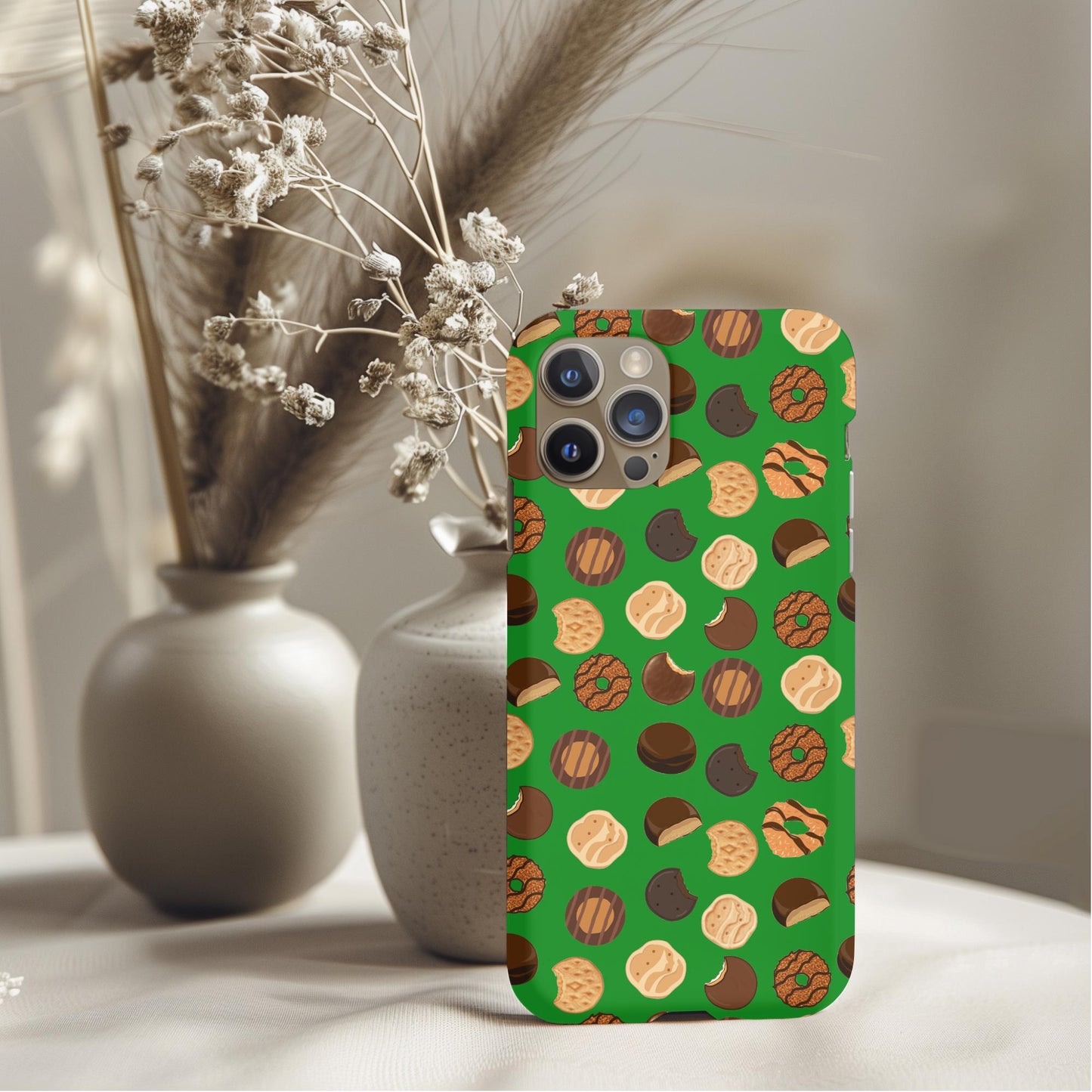 Girl Scout Cookie Season Phone Case with cookie pattern on green background displayed on table with vases