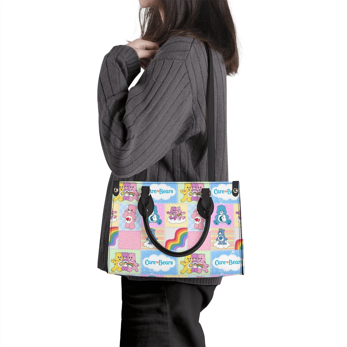 Woman wearing a Nostalgic Care Bears Patchwork Leather Handbag with colorful bear designs and rainbow accents at her side