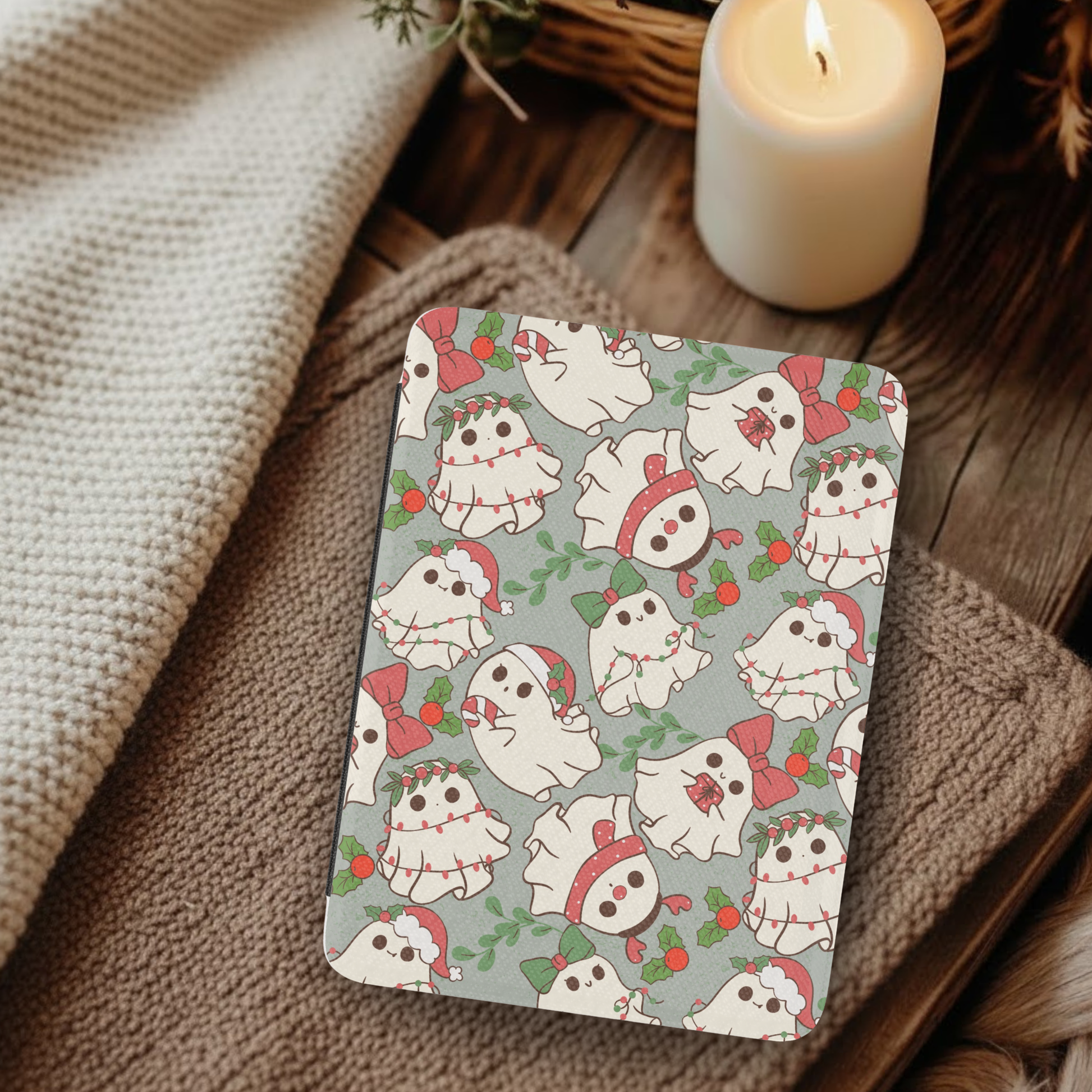 Christmas Ghosties Leather Kindle Case with Hand Strap featuring festive ghost patterns on a cozy rustic background