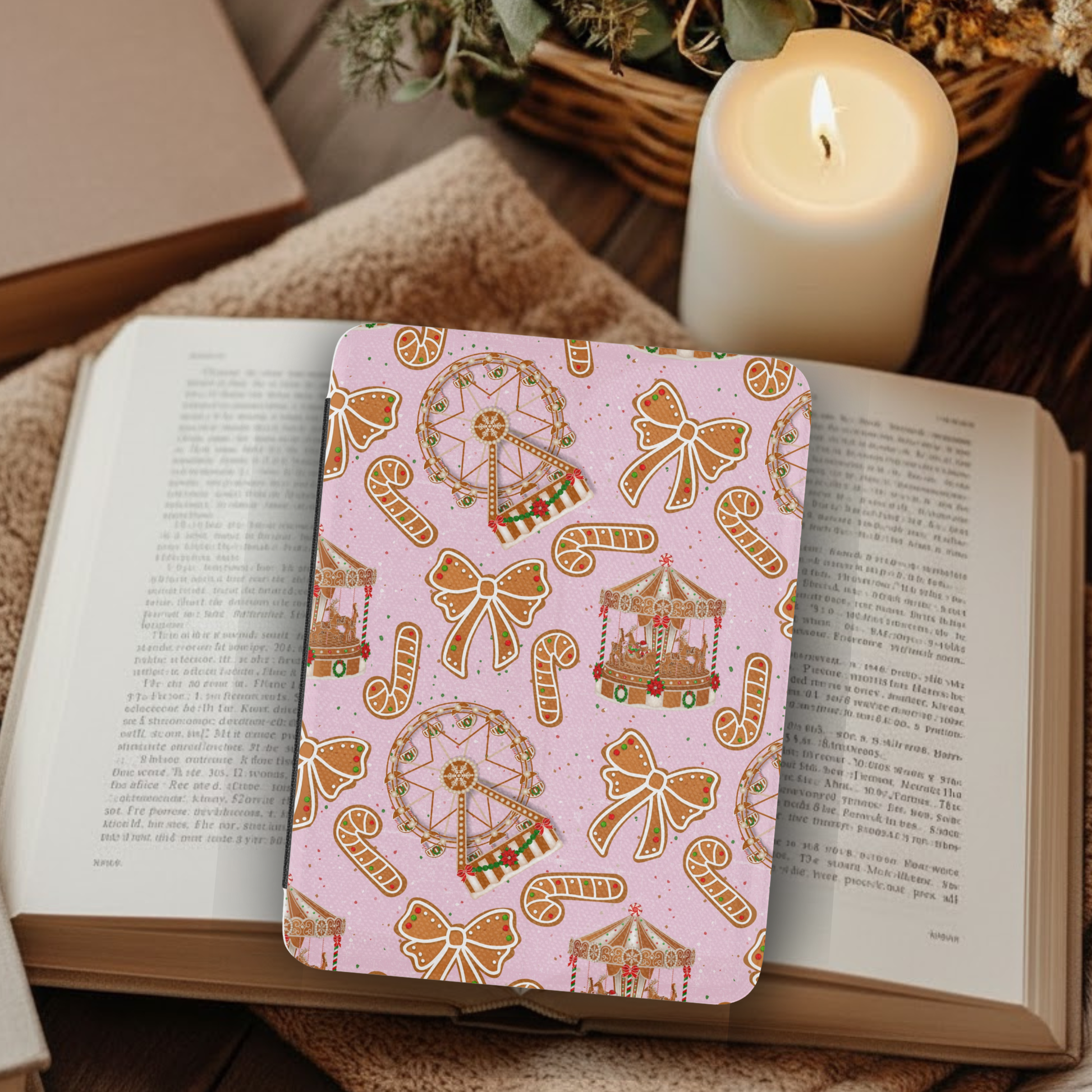 Gingerbread Cookies Fair Leather Kindle Case with Hand Strap placed on an open book with a lit candle nearby