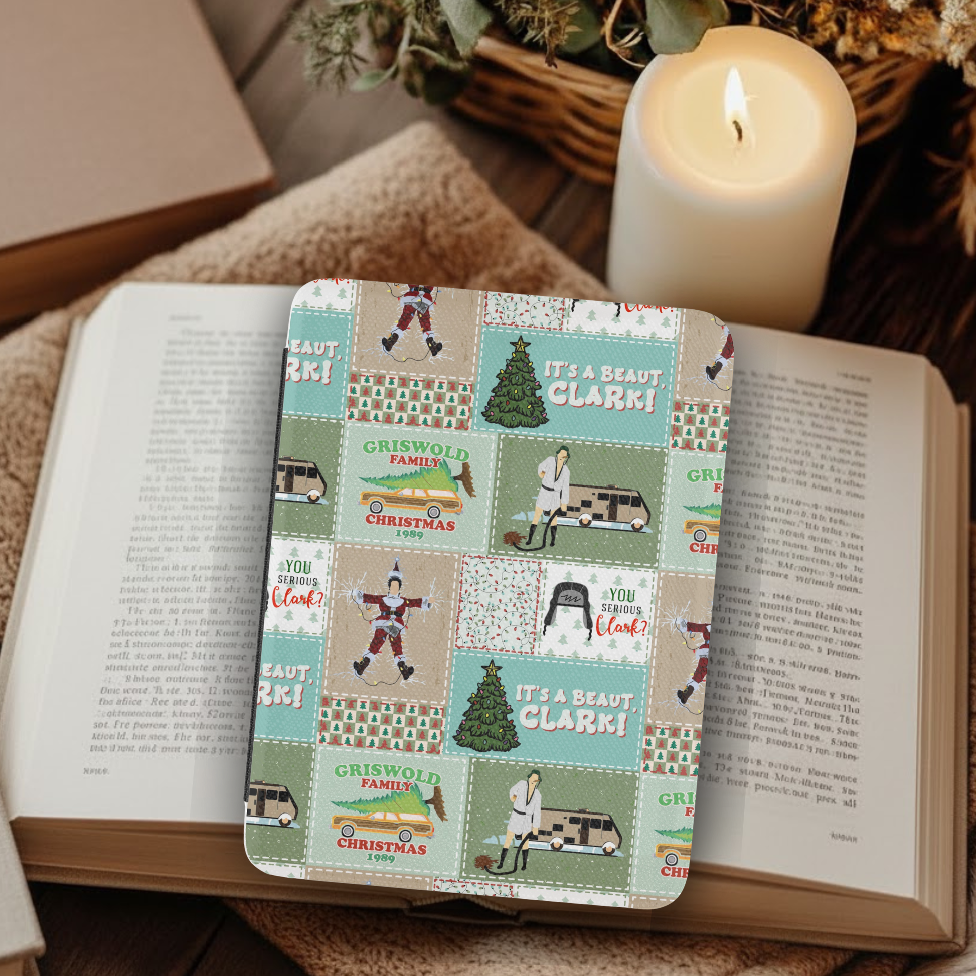 Christmas Vacation Patchwork Leather Kindle Case with Hand Strap featuring festive holiday-themed patchwork design on a cozy wooden table.
