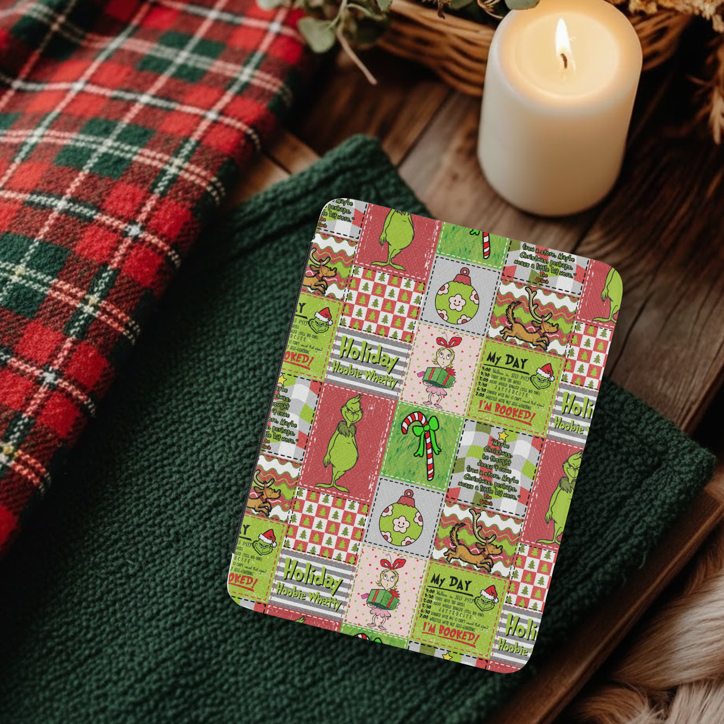 Christmas Grinch Patchwork Leather Kindle Case with Hand Strap on green cloth near candle and plaid fabric