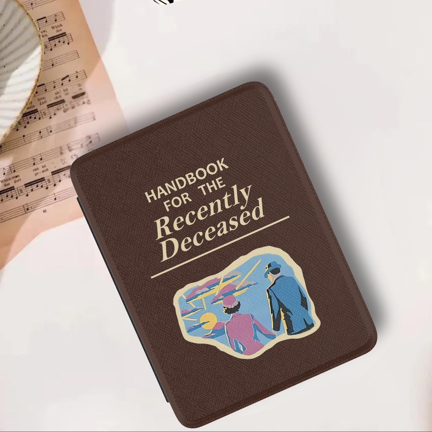 Handbook for the Recently Deceased Leather Kindle Case with Hand Strap in brown with vintage illustration on cover